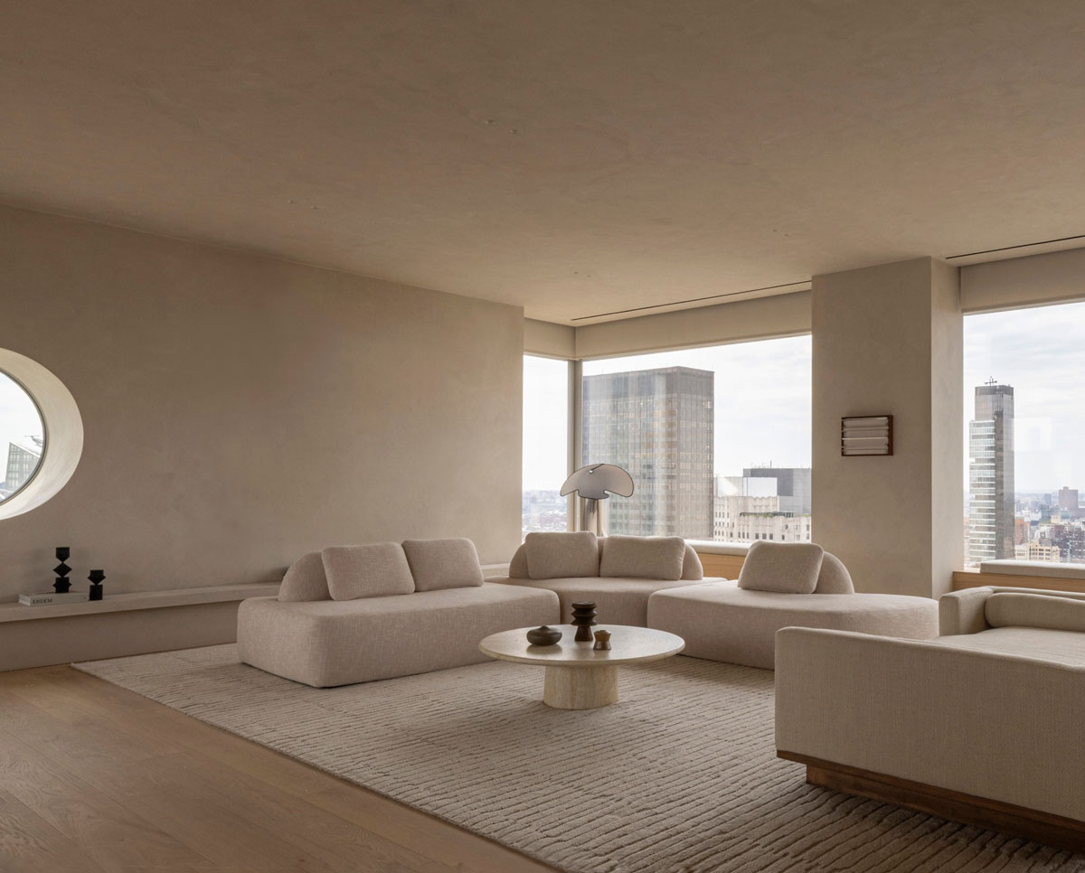 Minimalist luxury living room design with sculptural sectional and monotone color palette