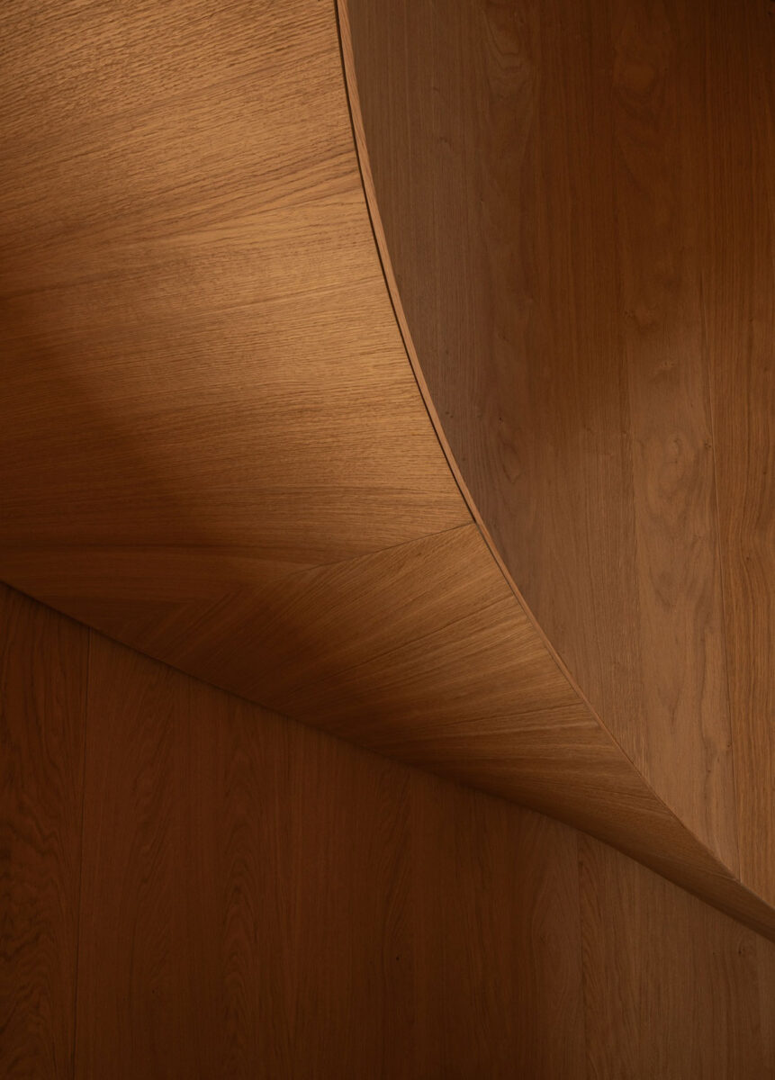 Custom curved wood staircase by Norm Architects