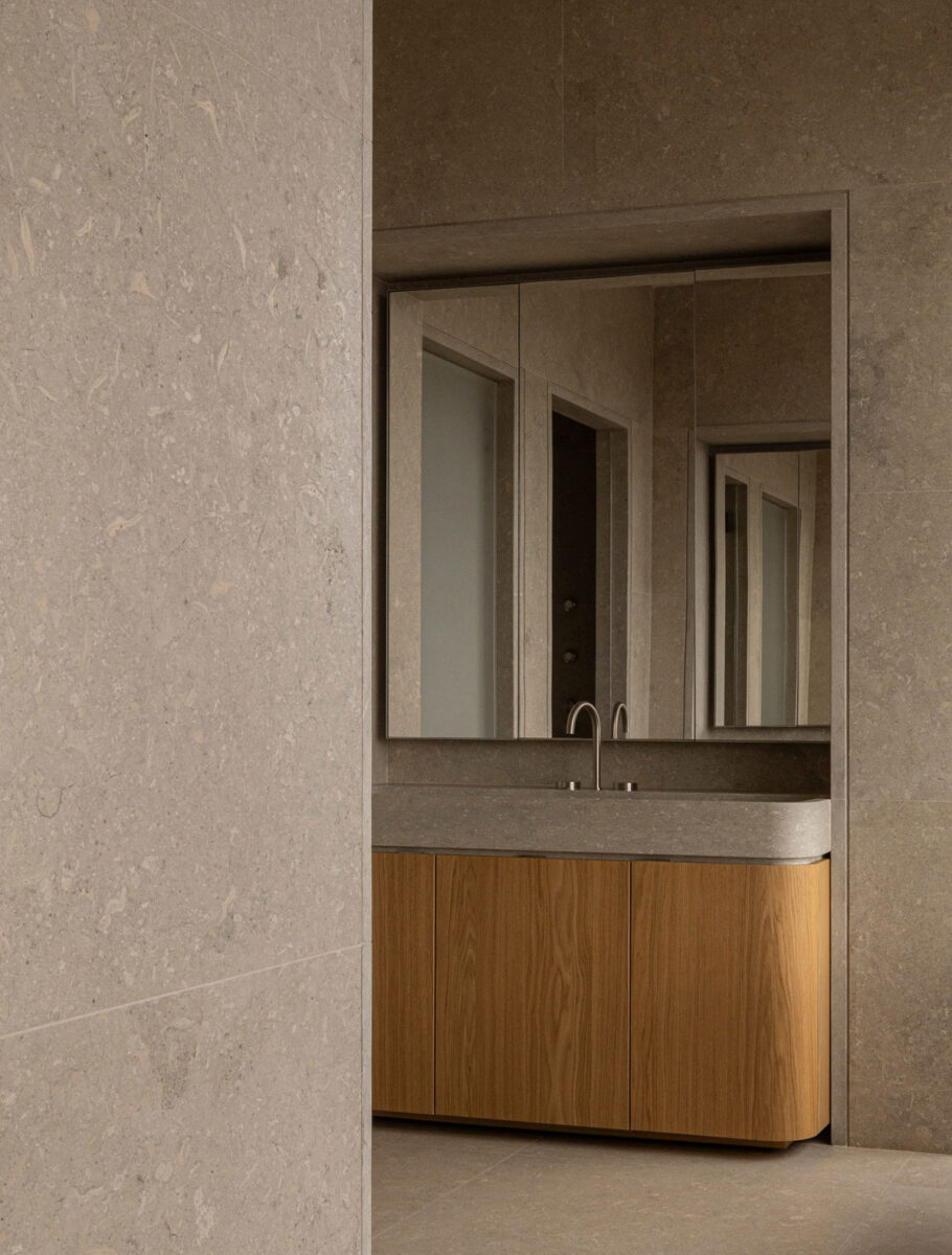 Minimalist luxury bathroom sink in oak wood, Grigio Alpi marble, and sculptural details