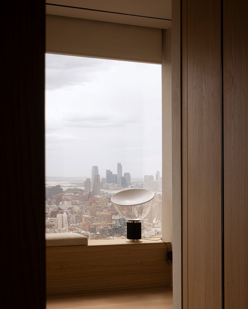 Norm Architects interior with natural oak detailing and framed Manhattan skyline views
