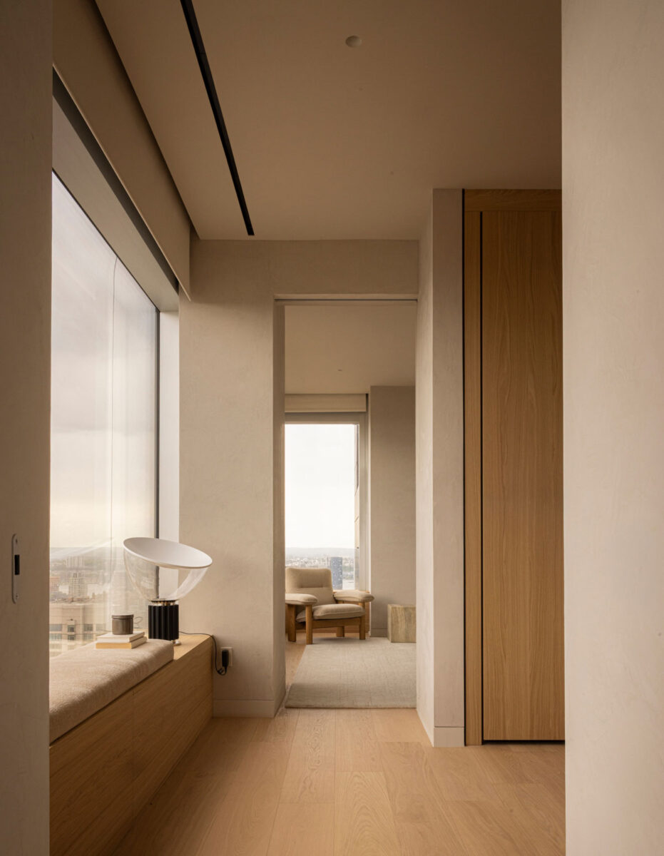 Contemporary closet and windowseat off of a bedroom interior with warm wood, neutral textures