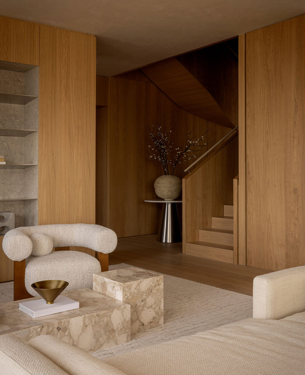 Sculptural staircase with warm wood finishes in a contemporary luxury apartment