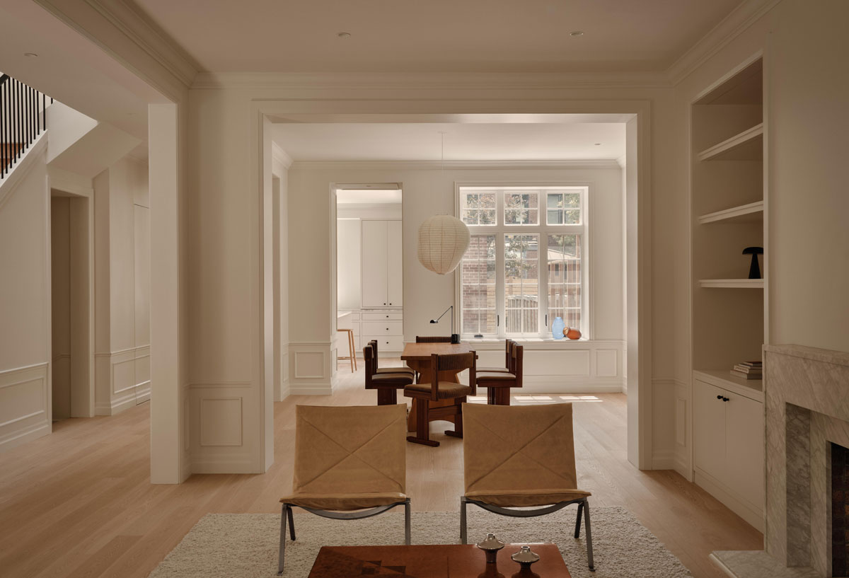 Wood Residence living room with built-in bookshelves, natural stone fireplace and white oak floors