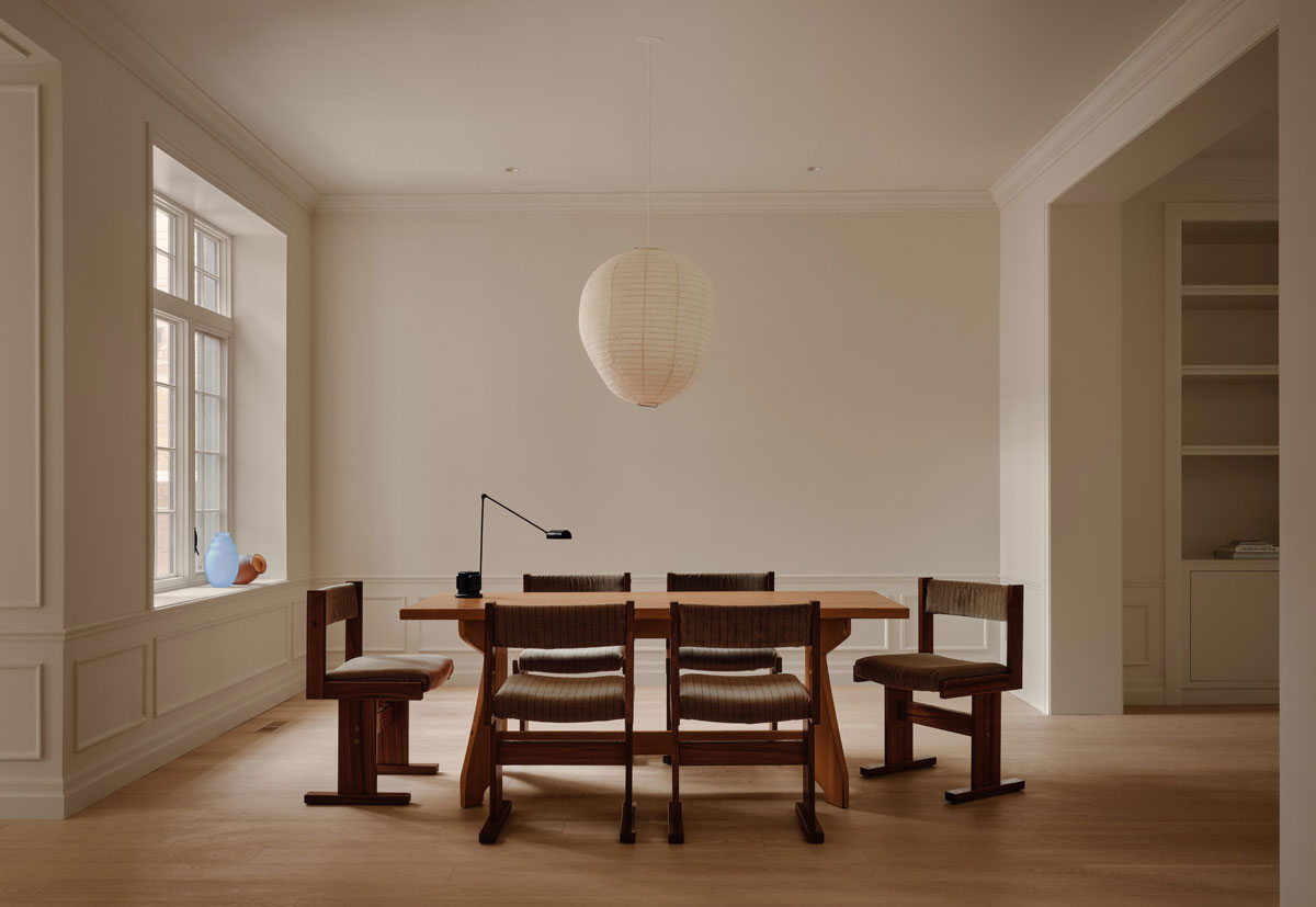Contemporary dining room in Westmount Montreal with dark wood furniture and soft neutral interiors