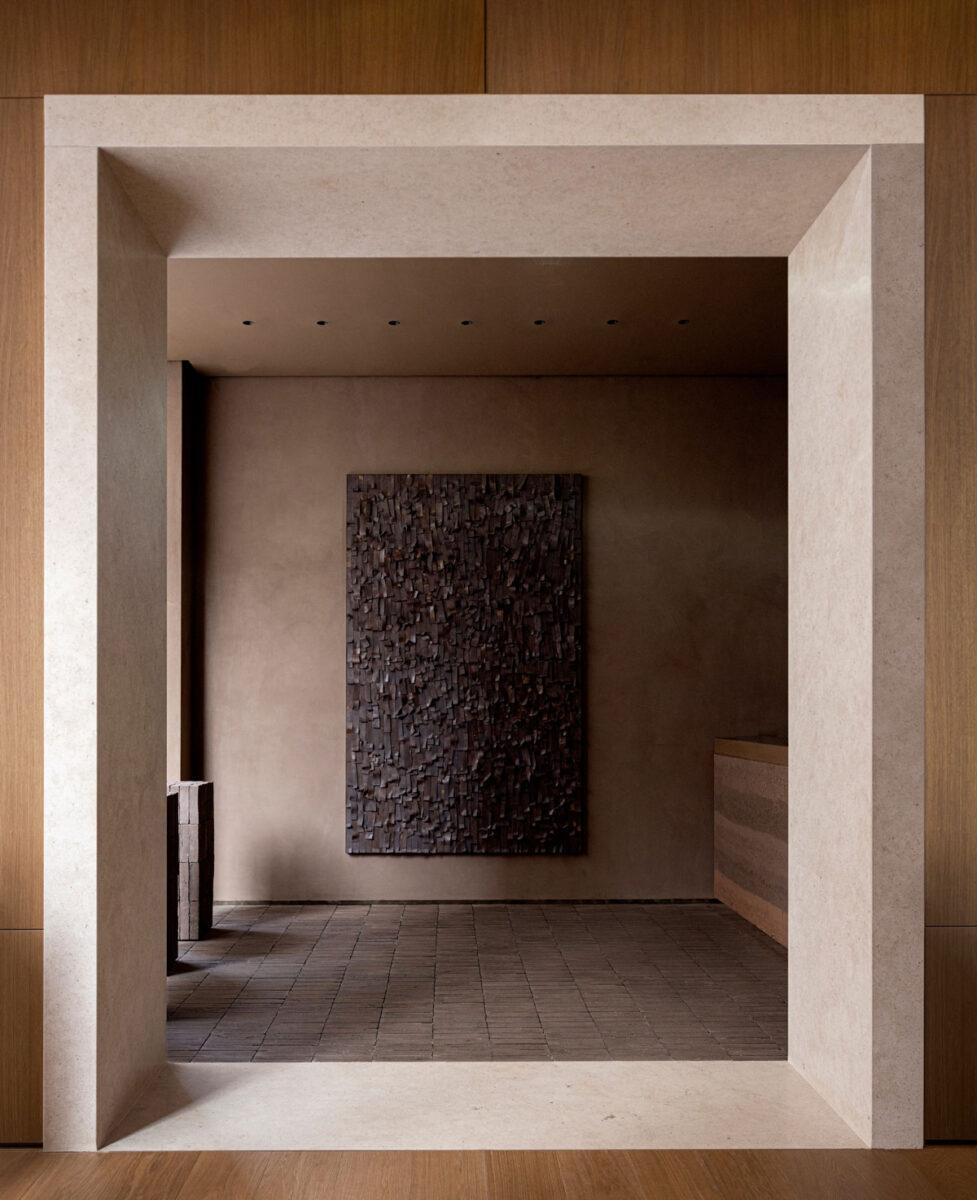 Pale stone-framed doorway leading to the clay room and its ceramic artwork.