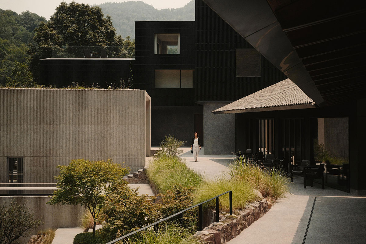 Contemporary resort courtyard with stone walls, contemporary landscape architecture, and outdoor seating