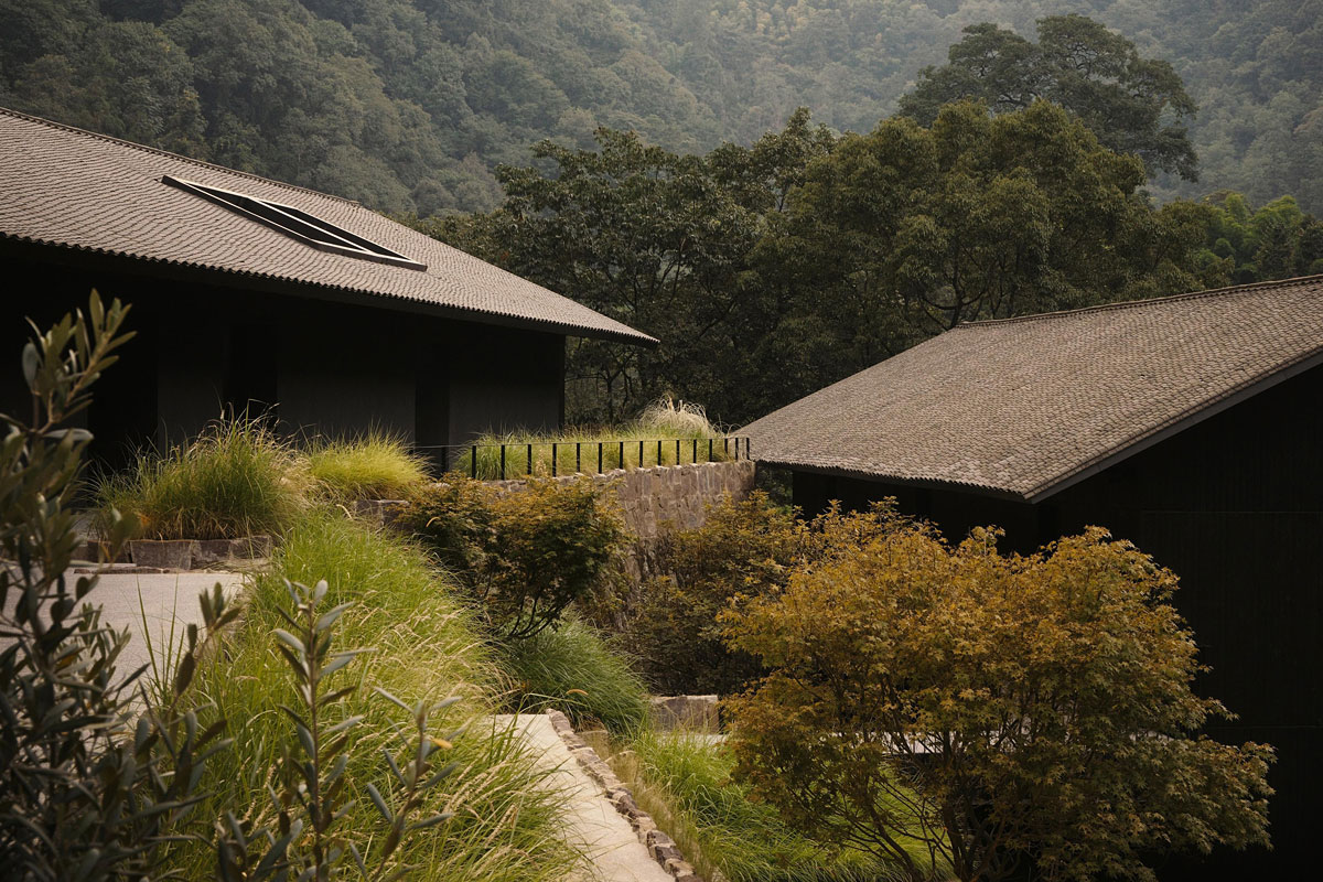 Landscaped garden path winding between timeless mountain resort villas