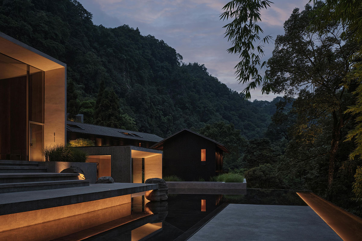 Modern mountain resort and infinity pool illuminated at twilight