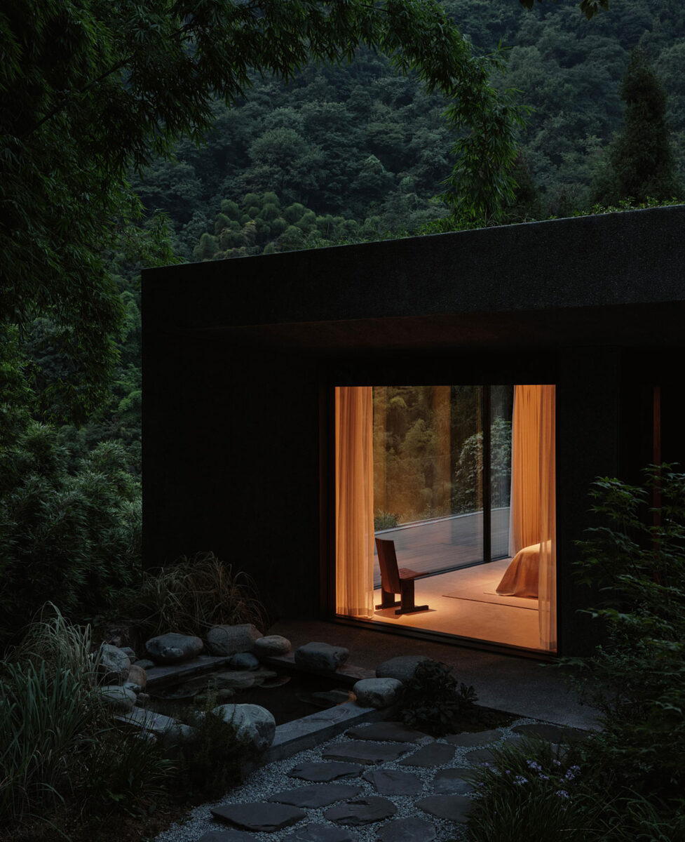 Private bedroom with floor-to-ceiling windows, a green roof, and a small garden water feature